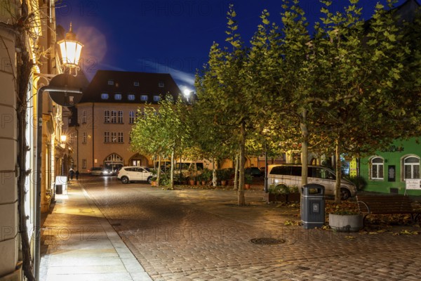 Atmospheric night view at a small market with a full moon, Meissen, Saxony, Germany