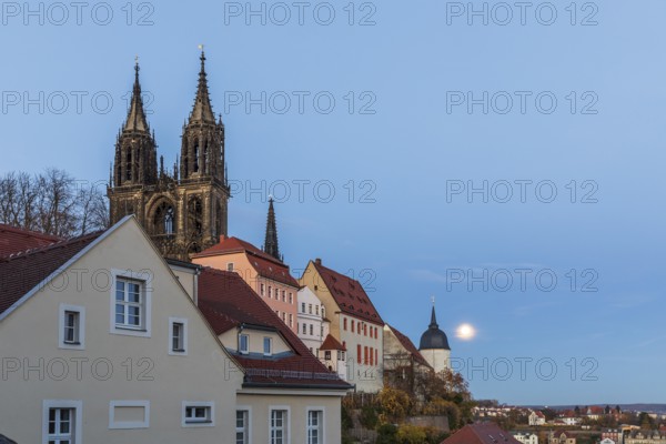 Full moon on Burgberg and over the old town at blue hour in Meissen, Saxony, Germany