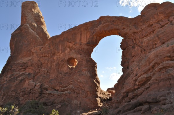Turret Arch, an impressive sandstone rock arch under a clear blue sky, formed by natural erosion, Arches National Park, Utah, USA
