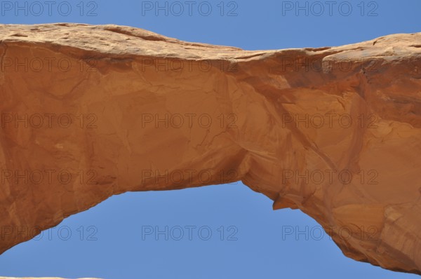 Skyline Arch, a sand-colored rock arch standing out against the blue sky, Arches National Park, Utah, USA