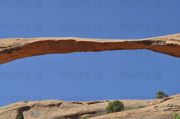 Close-up of a natural stone bridge, called Landscape Arch, against the blue sky, Arches National Park, Utah, USA