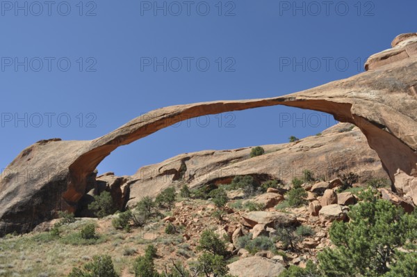 Landscape Arch, a natural sandstone bridge with clear sky in the background, Arches National Park, Utah, USA