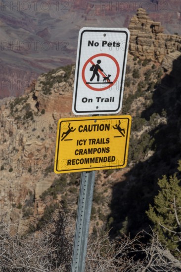 Grand Canyon National Park, Arizona - A sign at the head of a trail leading into the Canyon in winter warns hikers that trails may be icy and that they should use a traction device