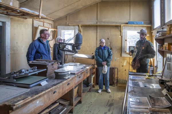 Grand Canyon National Park, Arizona - A park ranger gives a tour of the historic Kolb Studio on the Canyon's South Rim. In 1903, Ellsworth and Emery Kolb established their photography studio and home here and photographed mule riders descending the Bright Angel Trail