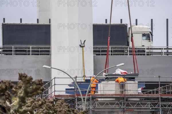 Duisburg-Neuenkamp Rhine bridge, the A40 motorway, construction of the second bridge begins, bridge pillars are being built on the Du-Homberg side of the Rhine, truck on the completed first section of bridge, North Rhine-Westphalia, Germany