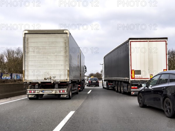 Driving on the A57 motorway, at the Kamp-Lintfort interchange, 3 lanes, traffic jam due to construction site, North Rhine-Westphalia, Germany