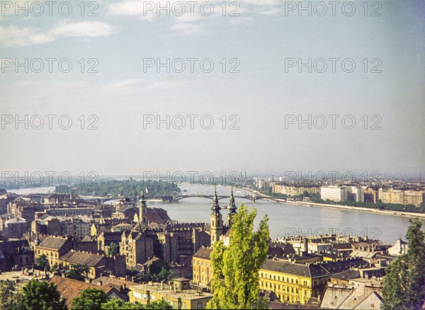 Cityscape over rooftops to River Danube, Budapest, Hungary, Europe 1967 view to Margaret Island and bridge