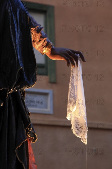 Sicily, old town of Trapani, Good Friday mystery procession La Processione dei Misteri, hand holding white handkerchief