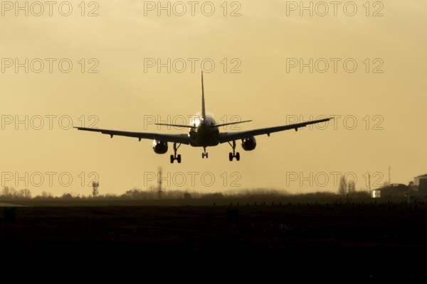 Airbus A320 commercial passenger airliner jet aircraft of Electra airlines flying on approach to land at sunset at London Stansted airport, Essex, England, United Kingdom