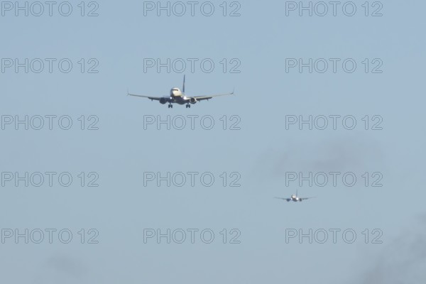Boeing 737 two commercial passenger airliner jet aircraft of Ryanair airways in flight on approach to land at London Stansted airport, Essex, England, United Kingdom