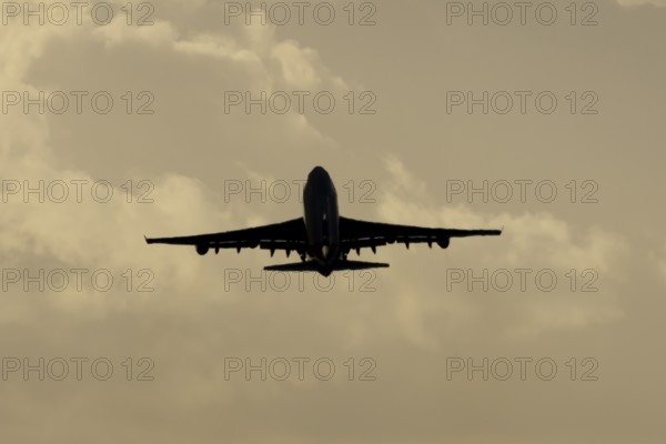 Boeing 747-400 jumbo jet LX-TCV commercial aircraft of Cargolux cargo taking off in flight silhouette at sunset at London Stansted airport, Essex, England, United Kingdom
