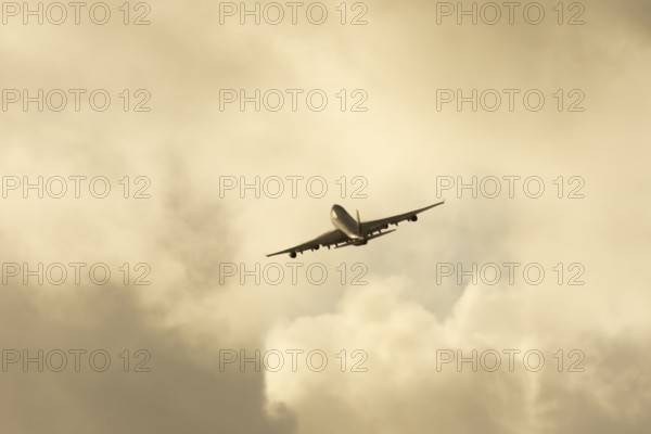 Boeing 747-400 jumbo jet LX-TCV commercial aircraft of Cargolux cargo in flight silhouette at sunset at London Stansted airport, Essex, England, United Kingdom