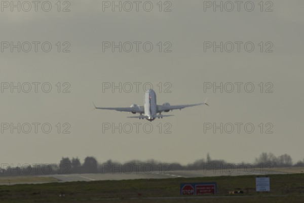 Boeing 737 commercial passenger airliner jet aircraft taking off in flight at London Stansted airport, Essex, England, United Kingdom