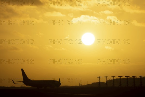 Boeing 737 commercial passenger airliner jet aircraft of Ryanair airlines moving onto the runway to take off at sunset at London Stansted airport, Essex, England, United Kingdom