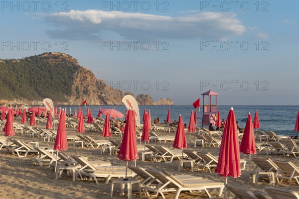 Alanya, Turkey. July 9th 2024 Sunbeds and pink sunshades on Cleopatra Beach in the Turkish holiday resort town of Alanya on the Mediterranean coast of Turkey, the Turkish Riviera