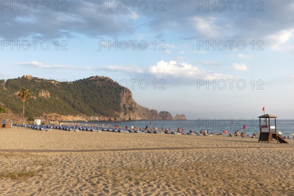 Beautiful wide sandy beach on the Mediterranean coast of Turkey in the popular package holiday resort of Alanya, in the Antalya region of the Turkish Riviera