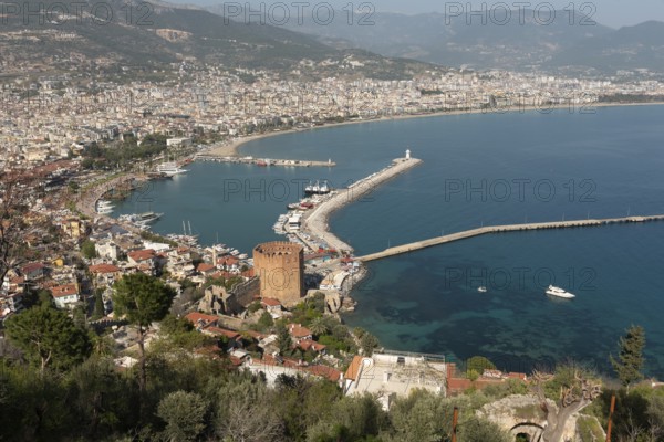 Alanya, Turkey. April 7th 2021 Landscape view of Alanya Harbour and the Red Tower with the Taurus Mountains and Mediterranean sea, Turkey