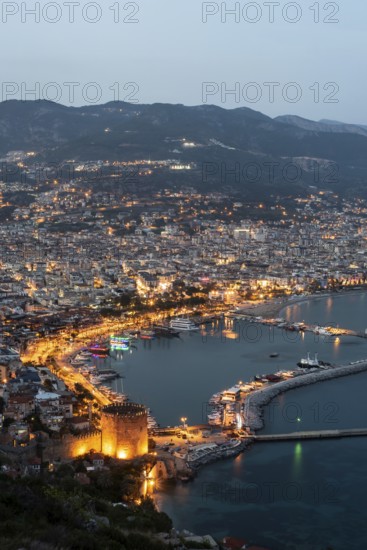 Alanya, Turkey. April 6th 2021 Beautiful portrait of Alanya Harbour and the Red Tower at night with the Taurus Mountains and Mediterranean Sea, Turkey