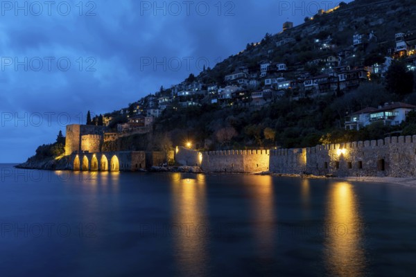 Alanya, Turkey. April 8th 2021 Beautiful view of Alanya peninsular and the old Shipyard and castle walls from the harbour at night