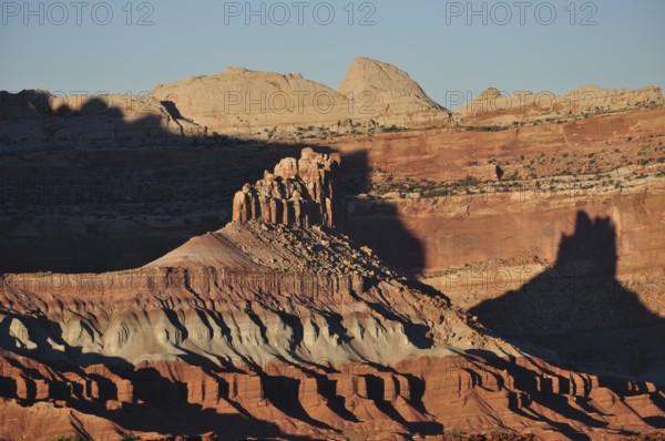 Rock formations in the desert with long shadows and red rock in the evening light, Capitol Reef National Park, Utha, USA