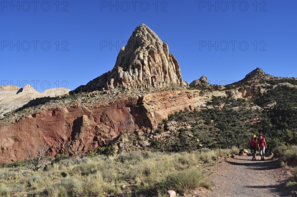 Proud rock formation rising above migrating people, Capitol Reef National Park, Utha, USA
