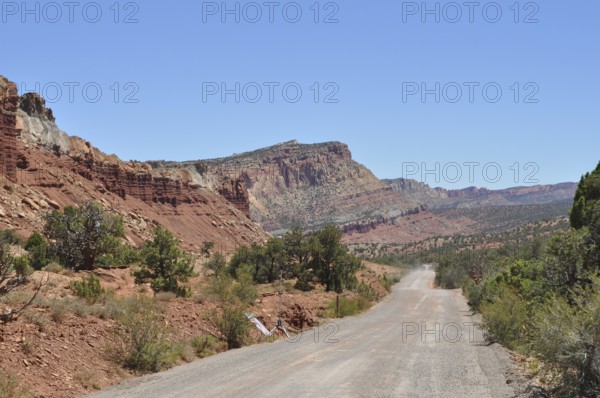 Gravel road through rolling red rock landscape, ideal landscape, Capitol Reef National Park, Utha, USA