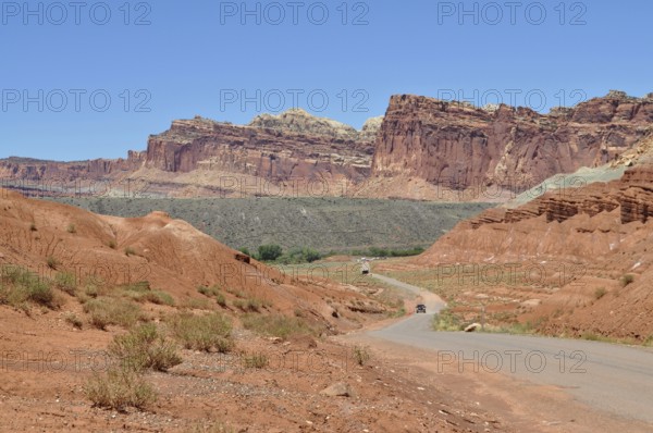 Extensive road through a landscape of red rocks and clear blue sky, Capitol Reef National Park, Utha, USA