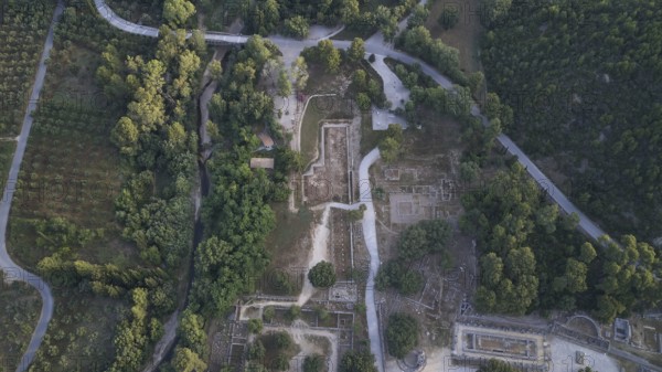 Olympic excavation site from high altitude, Temple of Zeus, Temple of Hera, Palestra Philippeion, etc. Historic ruins crisscrossed by roads and paths, surrounded by forest, aerial photo photographed, drone shot, archaeological excavation site, Ancient Olympia, Olympia, Peloponnese, Greece