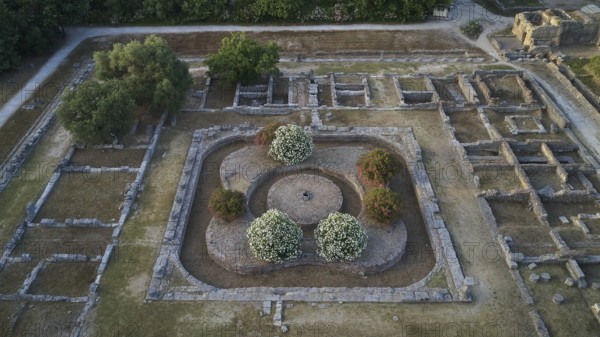 Soft morning light, central part of Leonidaion, aerial view of ancient foundations surrounded by trees and vegetation, drone view, archaeological site, Ancient Olympia, Peloponnese, Greece