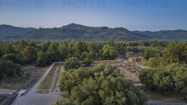 Soft morning light, Leonidaion, landscape with ruins and thick forests in the background, drone shot, archaeological site, Ancient Olympia, Olympia, Peloponnese, Greece