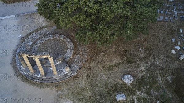 Philippeion, aerial view of ancient column formation and surrounding trees, drone view, archaeological site, Ancient Olympia, Olympia, Peloponnese, Greece