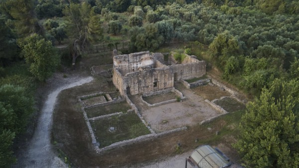 Building below Leonidaion, stone ruins of an ancient building surrounded by trees and paths, drone shot, archaeological site, Ancient Olympia, Olympia, Peloponnese, Greece