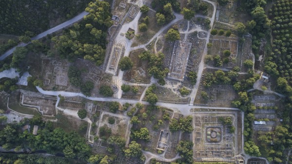 Olympic excavation site from high altitude, Temple of Zeus, Temple of Hera, Leonidaion, Palestra Philippeion, etc. Aerial view of an extensive ancient site with ruins and lush vegetation, drone shot, archaeological excavation site, Ancient Olympia, Olympia, Peloponnese, Greece