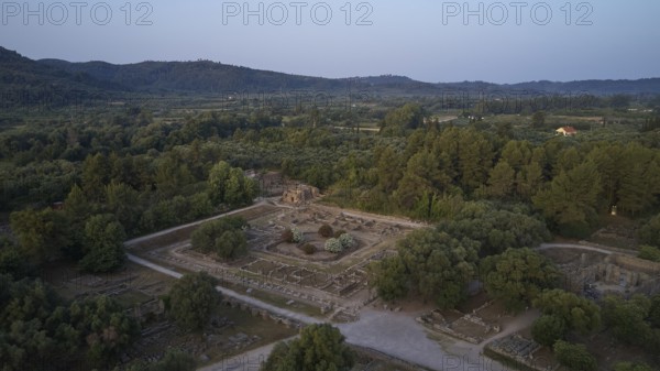 Leonidaion, archaeological ruins in landscape with trees and mountains in the background, drone shot, archaeological site, Ancient Olympia, Olympia, Peloponnese, Greece
