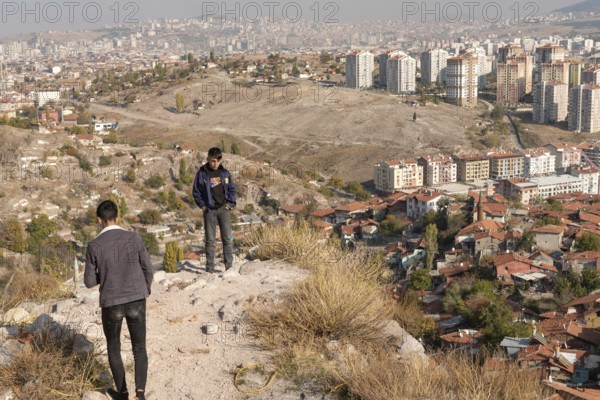 Ankara, Turkey. November 17th 2020 Young Turkish teens at Ankara castle with the urban sprawl of the capital city of Turkey