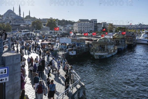Istanbul, Turkey. September 18th 2025. Panorama view of the busy Eminonu district beside the Golden Horn and boats selling Balik Ekmek a popular fish sandwich street food near the Egyptian Bazaar and Galata Bridge