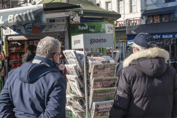 Istanbul, Turkey. January 3rd 2025. Turkish customers browse newspapers and magazines outside a kiosk in the Karakoy neighbourhood of Istanbul, Turkey