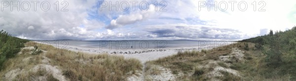 Panoramic view of secluded beach under cloudy sky, Rügen, Baltic Sea