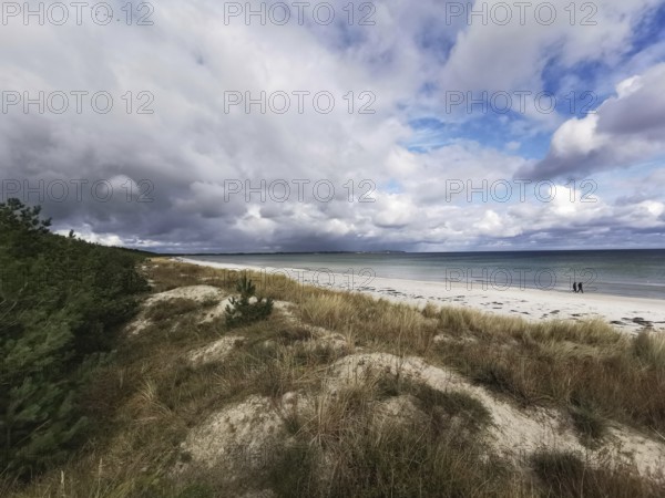 Quiet beach with clouds in the sky and dunes in the foreground, Rügen, Baltic Sea