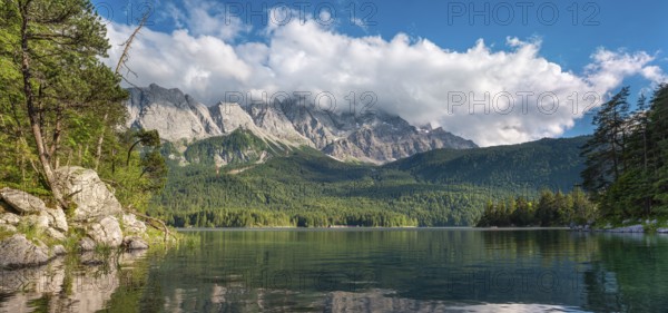 View over Lake Eibsee lake, the Wetterstein Mountains with the Zugspitze in the background, clouds moving across the peaks, Grainau, Garmisch-Partenkirchen, Bavaria, Germany