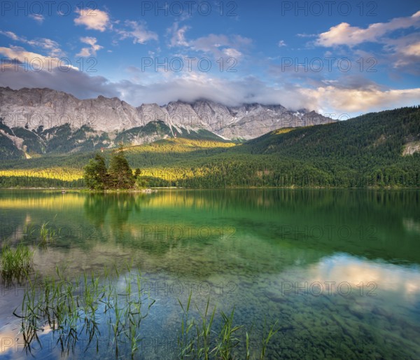Evening on Lake Eibsee lake, the Wetterstein Mountains with the Zugspitze in the background, clouds sweeping across the peaks, Grainau, Garmisch-Partenkirchen, Bavaria, Germany