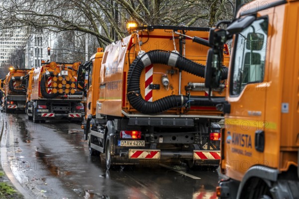 Sweeping on Rose Monday in Düsseldorf, the municipal utilities clean up after the train, confetti, camels, trash, employees with sweepers from AWISTA, Society for Waste Management and City Cleaning, central disposal and urban cleaning companies in Düsseldorf, clean the train's path with their street cleaning machines, North Rhine-Westphalia, Germany