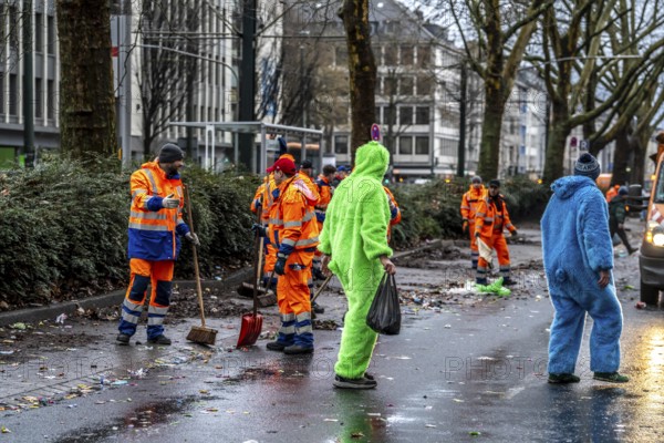 Sweep on Rose Monday in Düsseldorf, the municipal utilities clean up after the train, confetti, camels, trash, employees of AWISTA, Society for Waste Management and City Cleaning, central disposal and urban cleaning companies in Düsseldorf, clean the train's path with their street cleaning machines, North Rhine-Westphalia, Germany