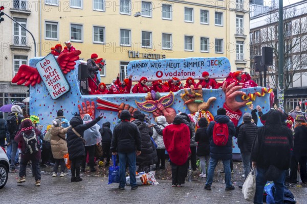Rose Monday procession in Düsseldorf, theme car from companies, here wholesale company Vodafone, at the street carnival, in some heavy rain, North Rhine-Westphalia, Germany