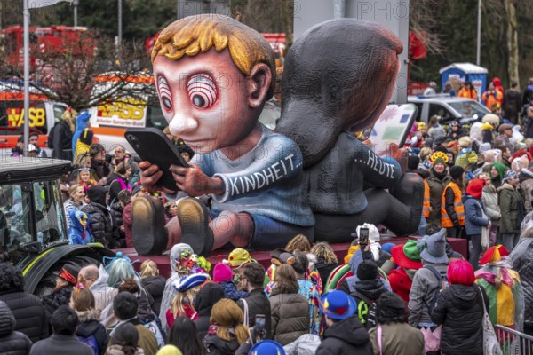 Rose Monday procession in Düsseldorf, theme car by wagon manufacturer Jacques Tilly, topic of smartphone addiction among children and adolescents, North Rhine-Westphalia, Germany