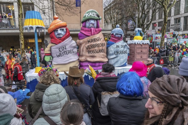 Rose Monday procession in Düsseldorf, theme car by wagon manufacturer Jacques Tilly, topic of suffering population in Ukraine due to Russia's war of aggression, destruction of energy supply infrastructure, freezing people in freezing cold weather, North Rhine-Westphalia, Germany