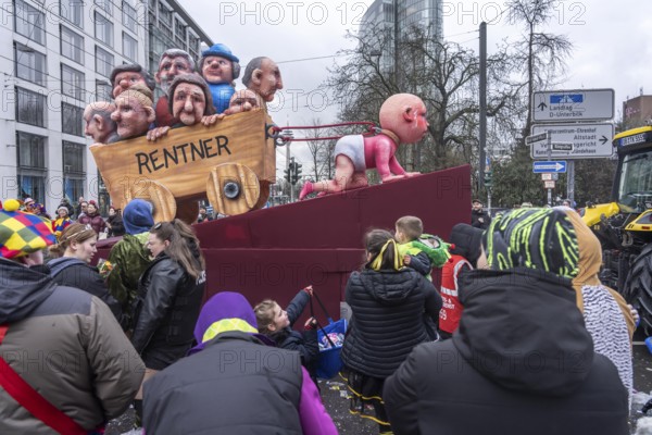 Rose Monday procession in Düsseldorf, theme car by wagon manufacturer Jacques Tilly, theme pension system, a baby pulls the cart with pensioners, problems in the current pension system, North Rhine-Westphalia, Germany