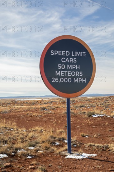 Winslow, Arizona - A speed limit sign on the road to Meteor Crater. The crater was formed about 50, 000 years ago. It is 560 feet deep and abouat three-quarters of a mile in diameter. It is now a major tourist attraction