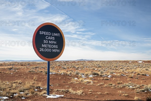 Winslow, Arizona - A speed limit sign on the road to Meteor Crater. The crater was formed about 50, 000 years ago. It is 560 feet deep and abouat three-quarters of a mile in diameter. It is now a major tourist attraction