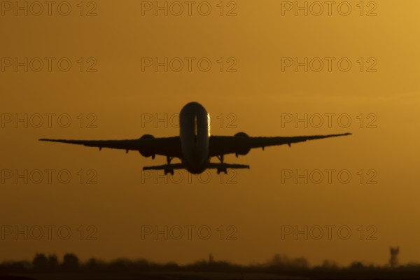 Boeing 777 A7-BFL commercial jet aircraft of Qatar cargo taking off in flight silhouette at sunset at London Stansted airport, Essex, England, United Kingdom